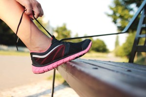 Athlete tying the laces of their running shoes