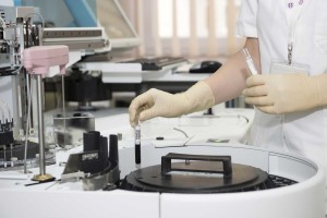 Doctor, Technician, using a centrifuge in a lab